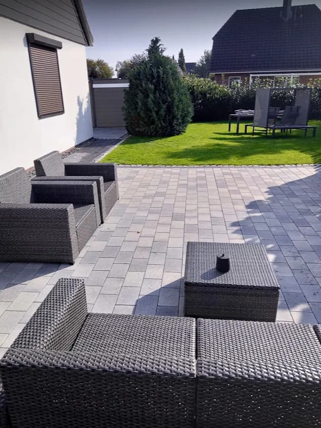 Terrasse aus grauem Betonsteinpflaster mit Loungemöbeln im Kreis Pinneberg